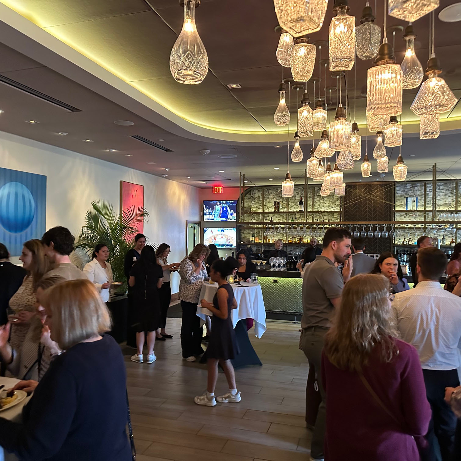 People network in a trendy bar setting at a professional conference.